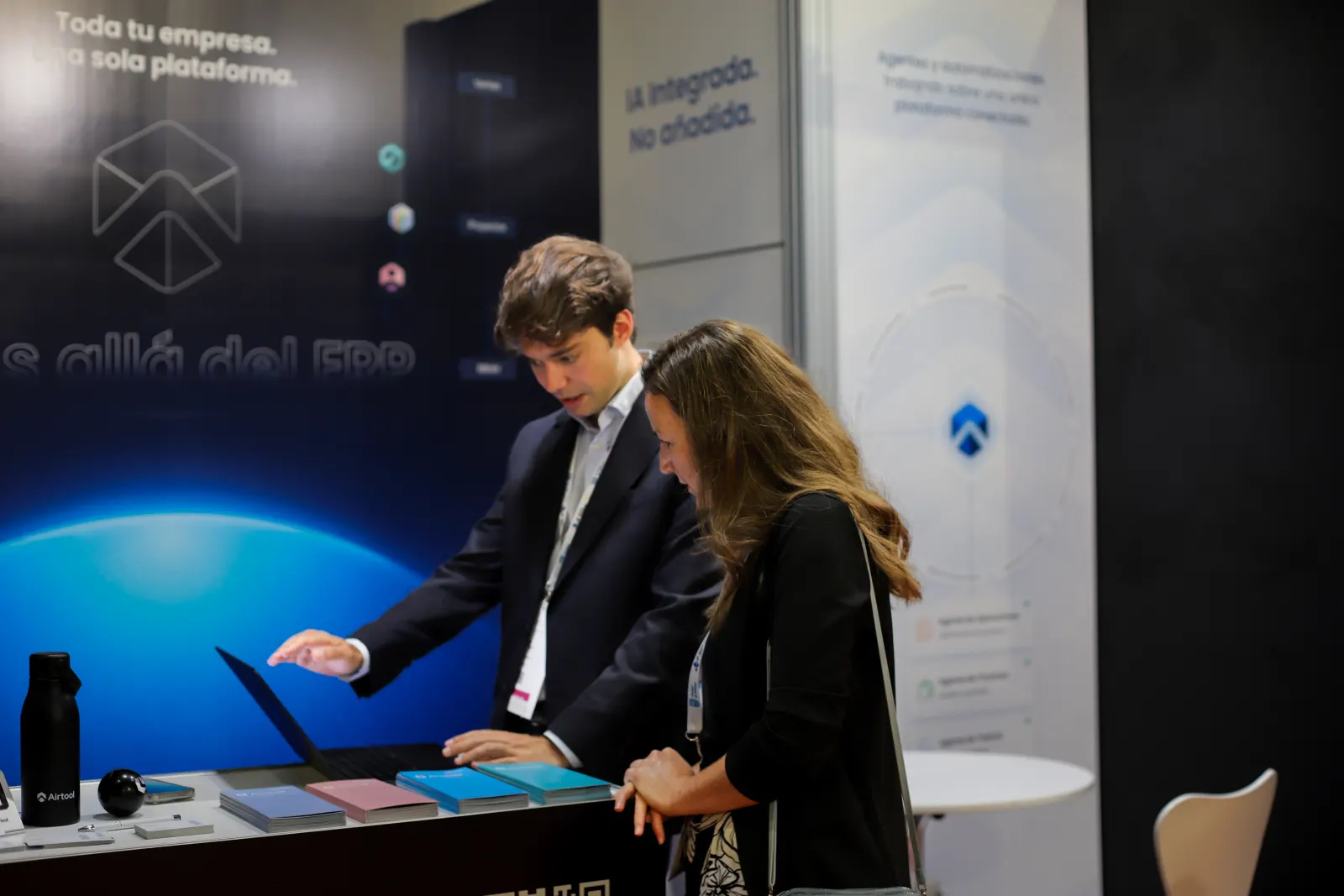 An Airtool engineer demonstrating the platform on a laptop to a visitor at the booth